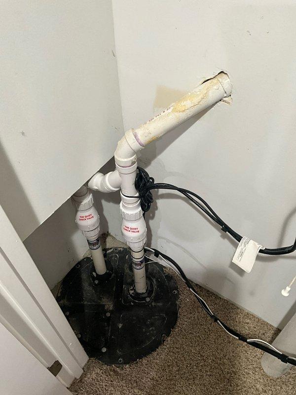 Completed pre-sale plumbing site visit to verify all systems operational. Inspected sump pump system including basin, discharge piping, and backup power failure alarm controller. Confirmed pump assembly properly installed with dual discharge lines, secure electrical connections, and functional float controller. Verified Deluxe Float Controller mounted and displaying operational status with backup battery system in place. All components found in working order with no immediate concerns identified.