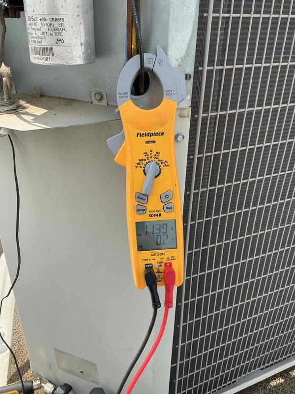 Completed commercial BFMA preventive maintenance tune-up on 11-year-old rooftop air conditioning unit accessed through dock area. Performed comprehensive system diagnostics including electrical testing of capacitor, contactor, and control components with digital multimeter, recording voltage readings of 437V and amperage draw of 14.92A to verify proper operation. Inspected condenser coil condition, electrical connections, and all major components to ensure optimal system performance and reliability for continued operation.