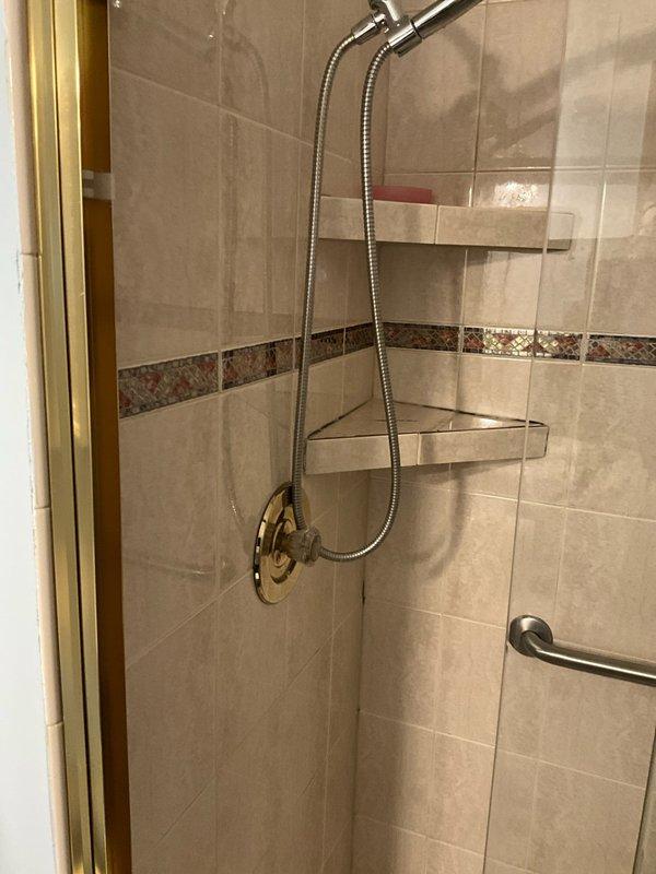 Responded to bathroom plumbing issue and successfully replaced corroded shower valve stem that was causing operational problems. The old valve stem showed significant oxidation and green patina buildup, which was replaced with a new brass component to restore proper water control functionality in the shower system.