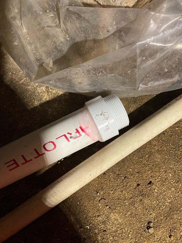 Responded to follow-up service call regarding sump pump system that previously exhibited burning smell near electrical outlet. Electrician had replaced outlet with grounded receptacle based on theory that water discharge was spraying overhead rafters and outlet during pump operation. Conducted comprehensive inspection of sump pump installation, discharge piping, and surrounding area. Examined PVC discharge line configuration and pump positioning within sump pit. Verified proper pump operation and assessed potential water spray issues. Documented existing conditions including deteriorated basement infrastructure, debris accumulation around sump pit area, and discharge pipe routing through overhead space. Confirmed system functionality and identified areas where water discharge pattern could impact nearby electrical components during high-volume pumping cycles.