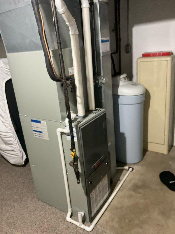 Completed comprehensive furnace and air conditioning tune-up on 12+ year old HVAC system. Performed full system inspection, tested electrical components with digital multimeter, verified proper operation of gas furnace and condensing unit, checked all safety controls, and inspected drainage system including PVC condensate lines. All equipment operating within manufacturer specifications at time of service.