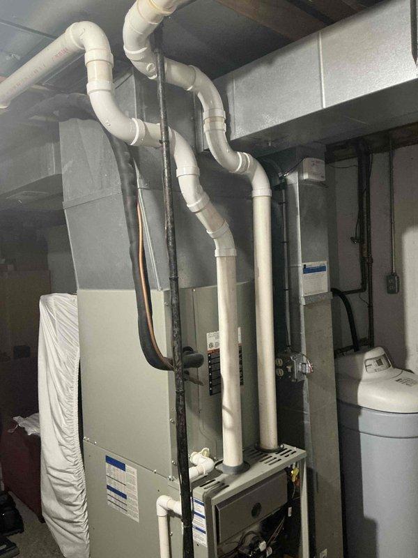 Conducted comprehensive assessment of existing HVAC system currently experiencing operational issues. Documented electrical panel configuration and existing mechanical room setup including furnace, ductwork, PVC condensate lines, copper refrigerant lines, and water heating equipment to prepare full system replacement estimate for residential heating and cooling installation.