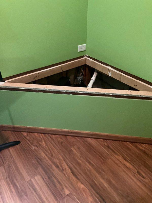 Responded to residential service call for drainage issues and sump pump assessment. Conducted thorough inspection of existing sump pump system, including examination of wall-mounted access panel containing plumbing infrastructure and evaluation of sump basin with yellow pump mechanism, discharge piping, and electrical connections. Documented current system condition and provided comprehensive estimate for sump pump solutions to address ongoing drainage concerns.