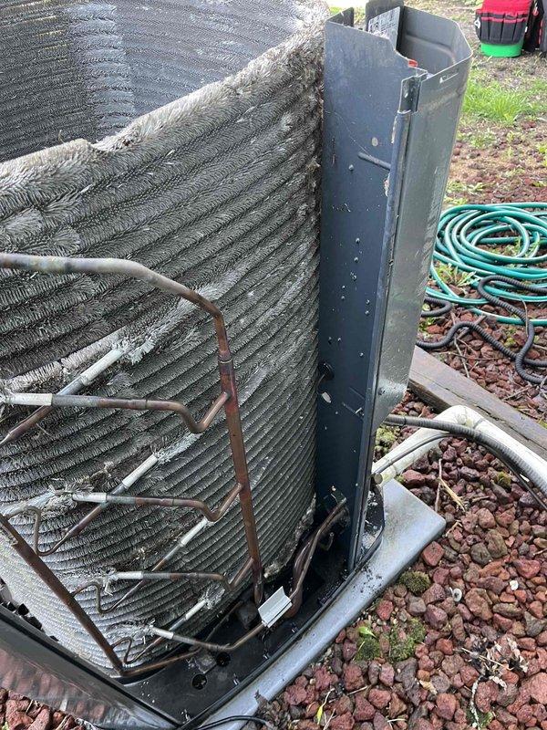 Responded to service call for outdoor condensing unit displaying error codes and failure to cool. Performed comprehensive BFMA tune-up on 8+ year old system, including inspection of refrigerant lines showing oxidation, examination of coil assembly and mesh housing, verification of electrical connections and fasteners, and diagnostic assessment of ductwork components. System evaluated for proper operation, all components cleaned and adjusted per manufacturer specifications, with photographic documentation captured for service records.