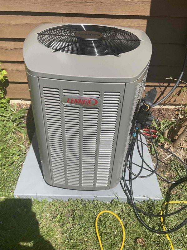Completed installation of a 4-ton Lennox EL15KC1 air conditioning condenser unit with matching horizontal B coil in crawl space application. The outdoor condenser was positioned on a concrete pad against the property fence with proper clearances maintained, refrigerant lines routed and connected, and electrical service established. The horizontal evaporator coil was installed in the crawl space and integrated with the existing ductwork system, with all connections properly sealed and insulated for optimal performance and efficiency.