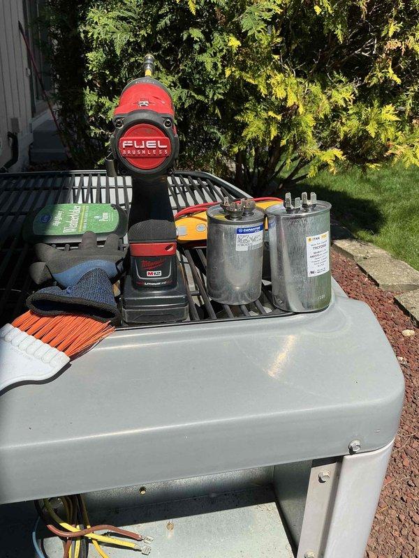 Completed comprehensive BFMA tune-up on 23-year-old air conditioning system. Removed access panel and cleared significant debris accumulation including dried leaves and dirt from unit base and interior components. Inspected condenser coil, electrical connections, and wiring harnesses; verified all terminal blocks secure and properly connected. Replaced dual-run capacitor with new component to ensure optimal compressor and fan motor operation. Cleaned exterior housing, tested system performance, and confirmed unit operating within manufacturer specifications.