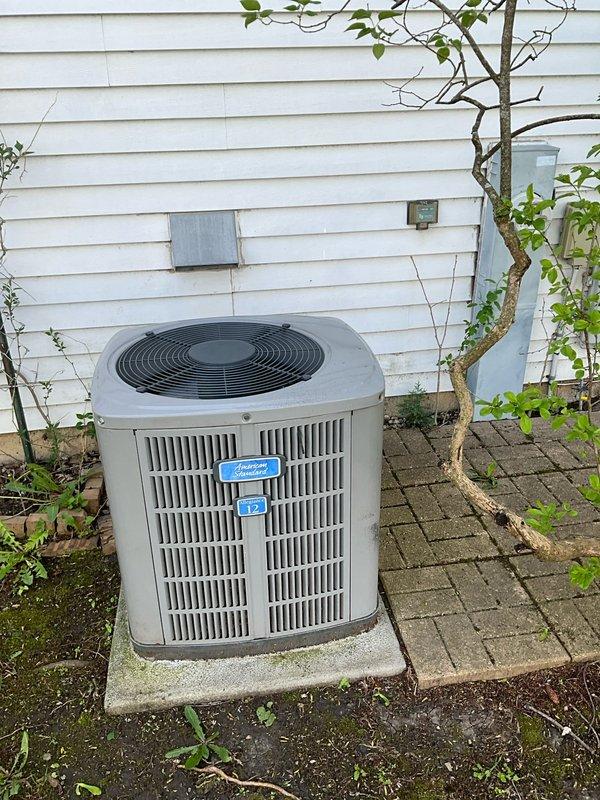 Completed comprehensive air conditioning tune-up on 24+ year old outdoor condenser unit. Performed standard maintenance protocol including inspection of electrical connections at contactor assembly, which showed significant oxidation and aging consistent with equipment age, cleaning of accumulated debris and cobwebs from terminal block area, and verification of proper system operation. Unit operational upon completion with customer advised of equipment age and condition.