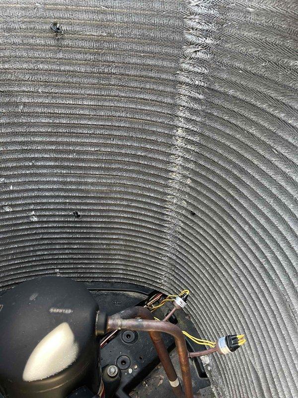Completed comprehensive BFMA tune-up on 8+ year old air conditioning system during morning appointment window. Performed full inspection of evaporator coil and Emerson motor assembly, verified refrigerant line connections and electrical components, and documented system condition with photographic evidence. All components were inspected and system is operating within normal parameters.
