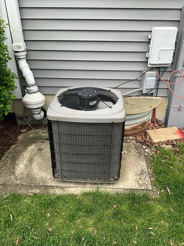 Completed full system estimate for residential HVAC replacement including outdoor air conditioning unit and indoor furnace with air handler. Documented existing equipment configuration showing outdoor condenser positioned on concrete pad with associated refrigerant lines, electrical disconnect, and PVC condensate drainage, as well as basement-installed furnace and air handler with existing venting system. Assessed complete system for replacement recommendations to ensure proper sizing and equipment selection for optimal home comfort and efficiency.