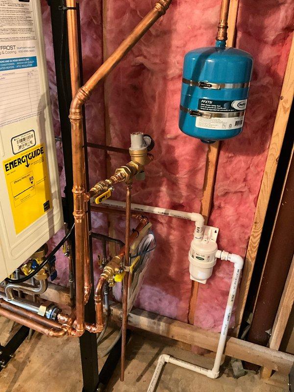 Responded to warranty call for tankless water heater system with faulty check valve. Diagnosed and confirmed defective check valve component within the tankless unit. Staged replacement part at headquarters for installation under existing warranty coverage. Inspected complete plumbing installation including copper piping, brass valves, expansion tank, and pressure relief components to ensure proper system operation. Verified water softener functionality and discussed water filtration options with client to optimize system performance and protect equipment longevity.