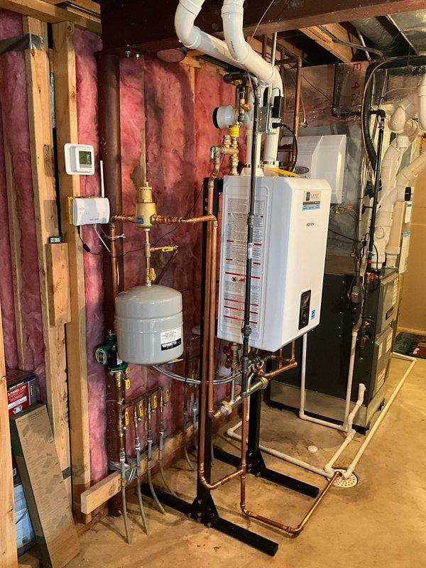 Responded to warranty call for tankless water heater system with faulty check valve. Diagnosed and confirmed defective check valve component within the tankless unit. Staged replacement part at headquarters for installation under existing warranty coverage. Inspected complete plumbing installation including copper piping, brass valves, expansion tank, and pressure relief components to ensure proper system operation. Verified water softener functionality and discussed water filtration options with client to optimize system performance and protect equipment longevity.