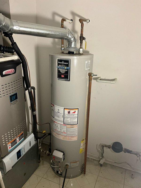 Conducted comprehensive water heater evaluation on an 8-year-old Bradford White 40-gallon natural gas unit (Model M140T6FBN) that had been recently flushed by the homeowner. Performed visual inspection of the tank exterior, verified all manufacturer labels and safety warnings were intact, assessed copper supply line connections at the top of the unit, and documented current condition with photographs for estimate purposes.