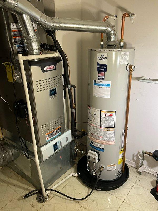Installed a new 40-gallon Bradford White tanked water heater in the residential utility room adjacent to the existing Lennox furnace. Connected copper supply and discharge lines to the top of the unit, secured all piping with appropriate hangers and strapping, and positioned the water heater on a code-compliant base platform with proper clearances for ventilation and service access.