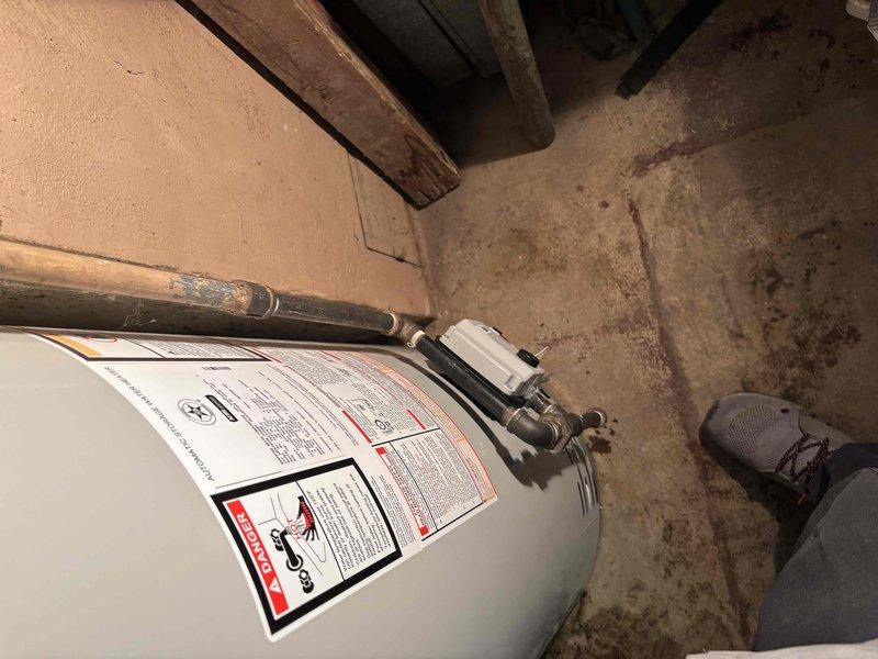 Removed and disposed of existing water heater from basement location. Installed new 50-gallon natural gas Bradford White water heater with 6-year tank warranty and 1-year parts and labor warranty. Modified and connected flue pipe, natural gas line, and water supply lines to ensure proper operation and code compliance.