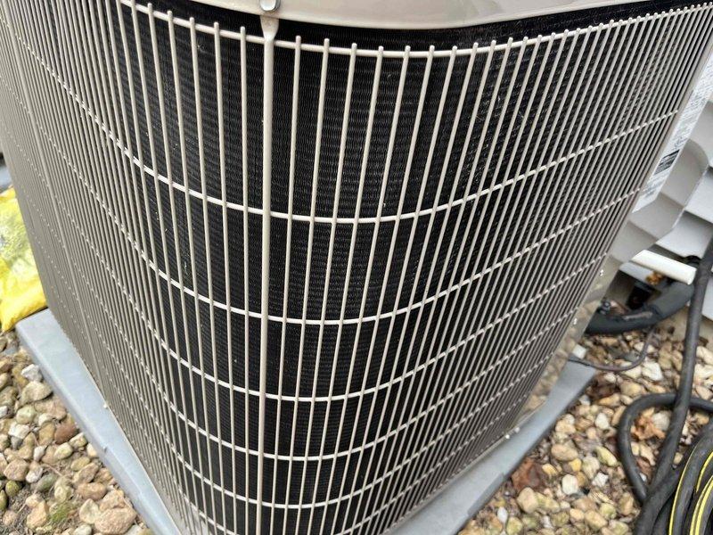 Completed comprehensive BFMA tune-up service on 7+ year old residential air conditioning system during afternoon appointment window. Performed thorough inspection and maintenance of outdoor condenser unit, including cleaning of condenser coils and fins which showed accumulation of dirt and debris between slats, verification of refrigerant line connections, and assessment of overall system operation. Unit was found to be structurally sound with all components functioning properly after maintenance procedures were completed.