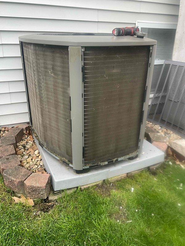 Completed comprehensive BFMA tune-up service on residential air conditioning system with equipment aged 1+ years. Performed standard maintenance procedures on outdoor condenser unit including inspection of cabinet condition, fan assembly, and protective grilles, with unit showing normal weathering consistent with age and outdoor exposure. All components inspected and system confirmed operational on concrete pad with adequate clearance for airflow and future service access.