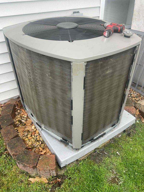 Completed comprehensive BFMA tune-up service on residential air conditioning system with equipment aged 1+ years. Performed standard maintenance procedures on outdoor condenser unit including inspection of cabinet condition, fan assembly, and protective grilles, with unit showing normal weathering consistent with age and outdoor exposure. All components inspected and system confirmed operational on concrete pad with adequate clearance for airflow and future service access.