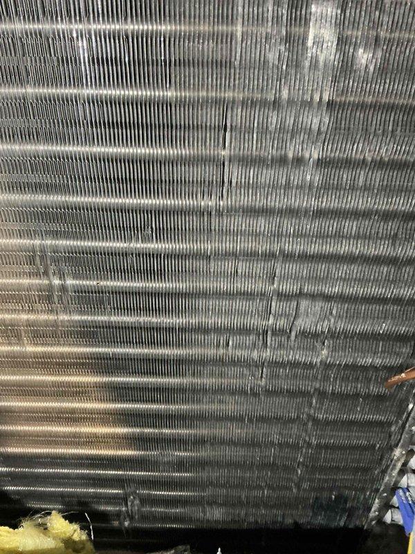 Completed comprehensive ACPTU tune-up with filter replacement on air conditioning system, addressing heavily soiled evaporator coil fins with significant dust, debris, and dark streaking indicating potential mold accumulation. Performed standard preventative maintenance protocol including inspection of 50-gallon natural gas water heater (Model G5RS40PSK32, 42,000 BTU input) manufactured March 2018, verified proper operation and safety compliance of all equipment.