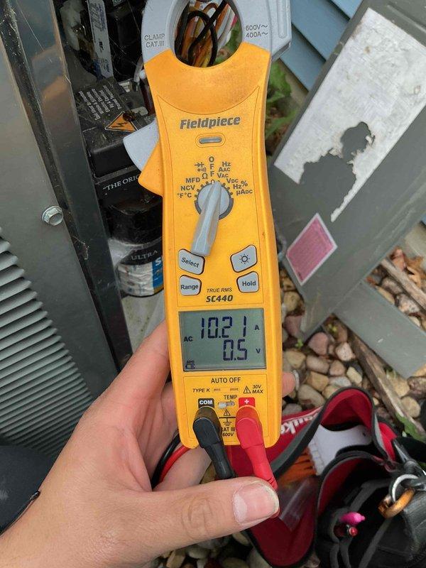 Completed comprehensive BFMA preventive maintenance tune-up on outdoor air conditioning condenser unit. Performed electrical diagnostics using digital clamp meter, recording voltage and amperage readings to verify proper system operation and compressor performance. Inspected condenser coil fins and noted significant accumulation of dirt, debris, and environmental contamination affecting heat transfer efficiency; cleaned coil surfaces to restore optimal airflow and cooling capacity. Verified all electrical connections, tested capacitor values, and confirmed unit operational parameters are within manufacturer specifications for the upcoming cooling season.