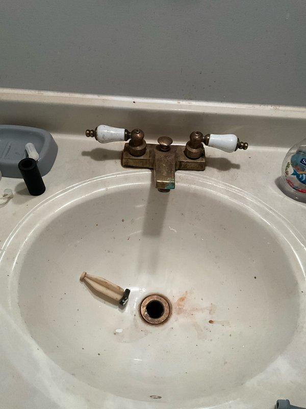 Completed comprehensive plumbing inspection as part of preventative maintenance tune-up service. Inspected kitchen sink plumbing system including P-trap configuration, garbage disposal unit, supply lines, and drain connections for proper operation and potential leaks. Evaluated bathroom sink fixture including aged brass faucet assembly, drain components, and associated hardware for functionality and wear. All accessible plumbing components were visually assessed and photographed for documentation purposes.