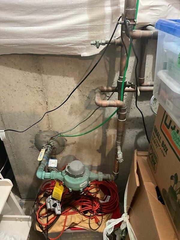 Completed complimentary plumbing inspection of residential water heater and main plumbing system. Inspected water heater unit, verified pressure gauge readings within normal operating range, and examined brass fittings and connections for proper installation and signs of wear. Assessed concrete floor area surrounding water heater for evidence of moisture intrusion or previous leaks. Inspected main water supply lines, including copper and coated steel piping, verified water meter operation, and examined all visible pipe joints and connections throughout utility area for potential leaks or deterioration. All plumbing systems found to be functioning properly with no immediate concerns identified.