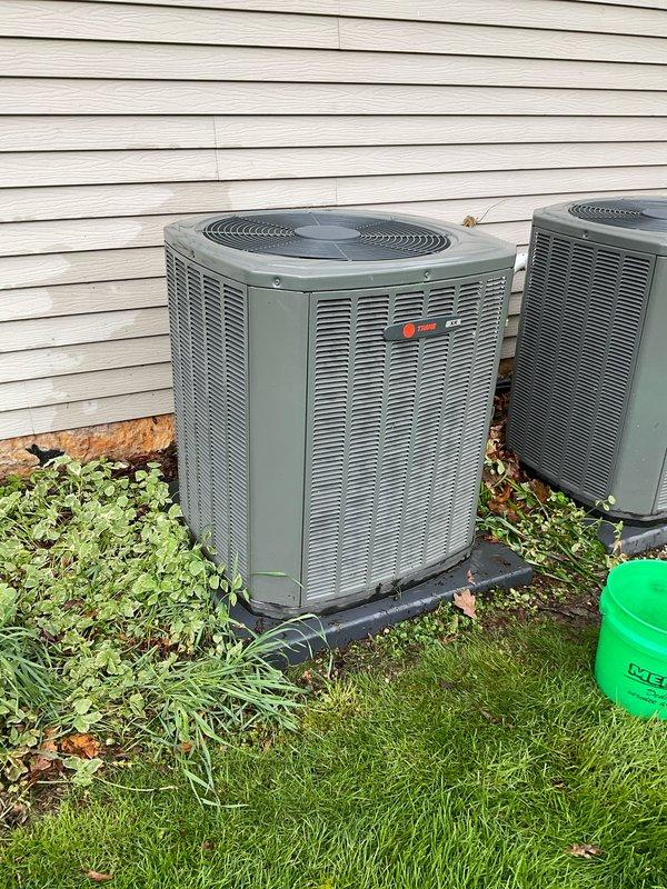 Completed BFMA tune-up service on two 6-year-old HVAC systems including air conditioning service and filter changes on both units. Performed comprehensive inspection of outdoor condenser units, removed top panels to access internal components, and evaluated condenser coils and fan motor assemblies for proper operation. Both systems were serviced according to semi-annual maintenance protocol with filters changed and equipment assessed for overall condition and performance.