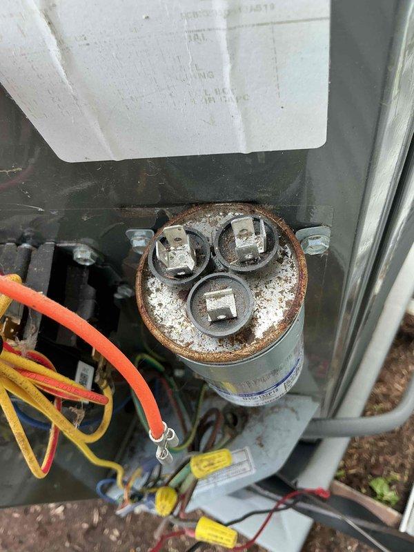 Completed semi-annual HVAC tune-up service that was previously delayed due to weather conditions. Performed comprehensive AC system inspection on 3-year-old unit, including electrical component evaluation, capacitor testing, and airflow verification. Noted significant corrosion and oxidation on dual-run capacitor with moisture intrusion around terminals, indicating potential failure risk. Inspected indoor air handler unit and replaced air filter #213 as part of recurring preventive maintenance program. Verified all electrical connections, tested system operation, and documented equipment condition with photographs for service records.