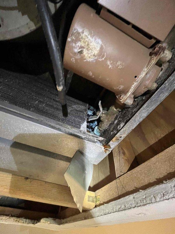 Conducted site assessment of ceiling-mounted air handler to gather complete measurements and specifications for hydronic coil installation quote. Documented existing equipment configuration, including deteriorated cylindrical component with mounting hardware, ductwork connections, and surrounding structural clearances. Captured detailed photographs of mechanical components, insulation placement, and access constraints to ensure accurate hydronic coil sizing and installation planning.