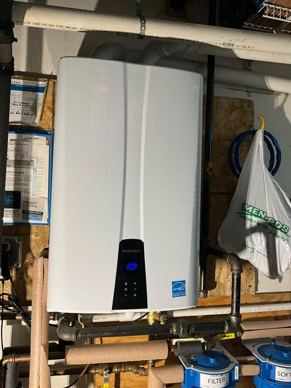 Performed comprehensive plumbing inspection and maintenance tune-up at residential property. Inspected Navien tankless water heater installation, verified proper operation with digital display reading 29°F, and examined all associated copper piping, brass fittings, valves, and insulated water lines for leaks or wear. Evaluated bathroom plumbing fixtures including sink faucet and drainage system to ensure proper function and identify any potential maintenance concerns.