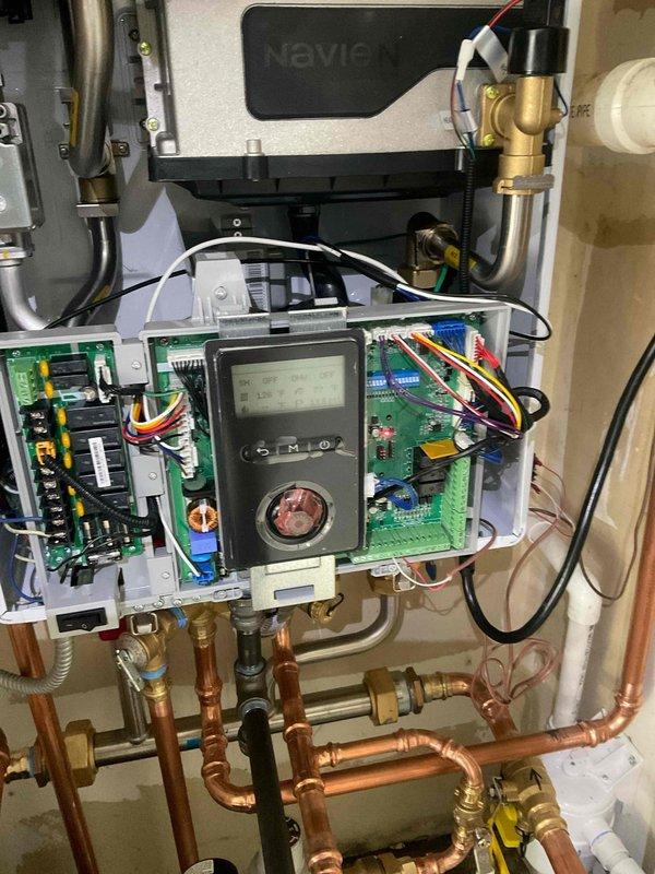 Responded to warranty callback for newly installed Navien combi boiler with continuous fan operation issue. Diagnosed and corrected improper control board wiring that original installation crew was unable to resolve with technical support. Verified all electrical connections to circuit boards, adjusted thermostat control wiring, and tested system operation to ensure proper fan cycling. System now functioning correctly with fan operating only on demand as designed.
