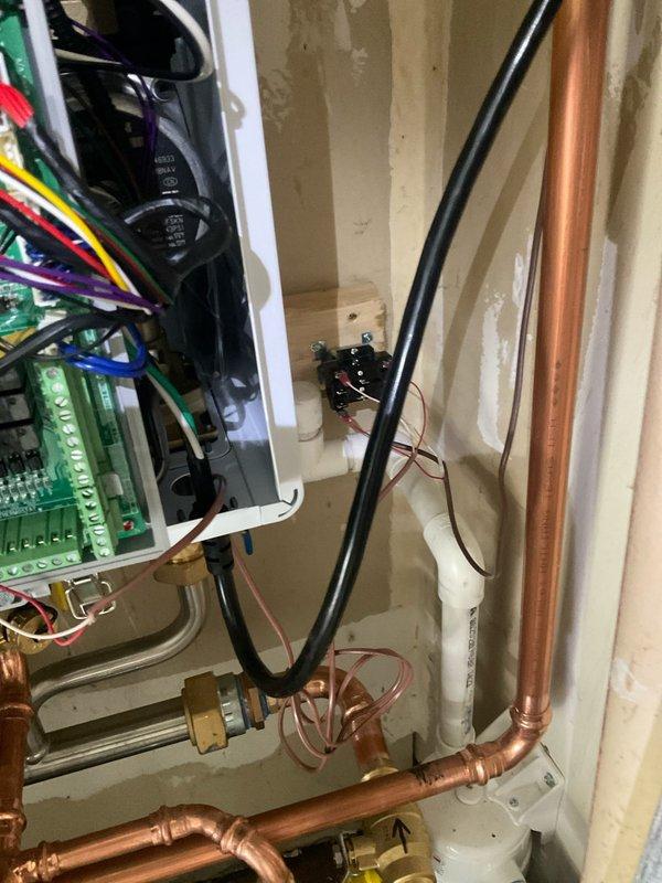 Responded to warranty callback for newly installed Navien combi boiler with continuous fan operation issue. Diagnosed and corrected improper control board wiring that original installation crew was unable to resolve with technical support. Verified all electrical connections to circuit boards, adjusted thermostat control wiring, and tested system operation to ensure proper fan cycling. System now functioning correctly with fan operating only on demand as designed.