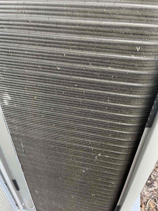 Completed comprehensive BFMA tune-up service on a 5-month-old Lennox air conditioning system. Performed full system inspection including condenser unit evaluation, coil condition assessment, and operational testing of all components. Observed minor dust and debris accumulation on heat exchanger fins consistent with normal outdoor exposure; fins maintained proper structural integrity and spacing. Verified unit positioning on concrete pad, checked electrical connections, and confirmed proper airflow through louvers. System operating within manufacturer specifications. Client provided with replacement air filter and advised regarding sump pump replacement estimate for potential same-day installation.