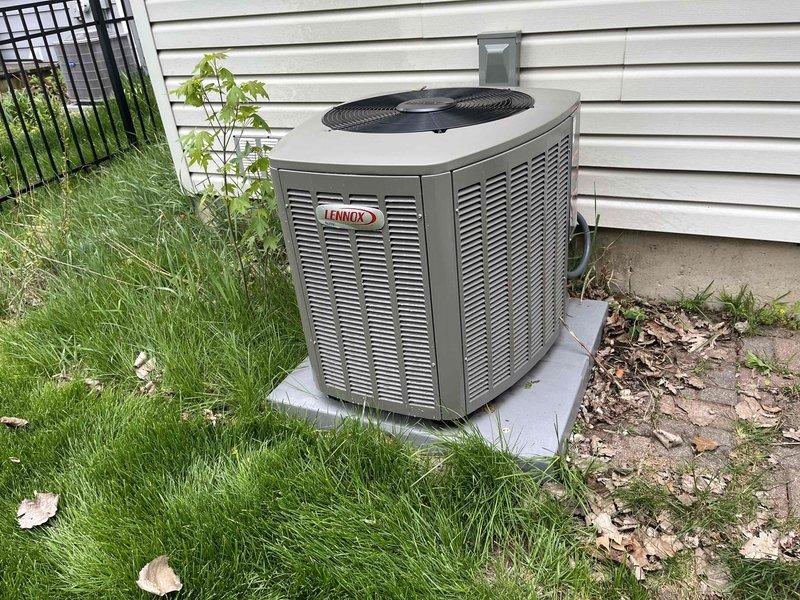 Completed comprehensive BFMA tune-up service on a 5-month-old Lennox air conditioning system. Performed full system inspection including condenser unit evaluation, coil condition assessment, and operational testing of all components. Observed minor dust and debris accumulation on heat exchanger fins consistent with normal outdoor exposure; fins maintained proper structural integrity and spacing. Verified unit positioning on concrete pad, checked electrical connections, and confirmed proper airflow through louvers. System operating within manufacturer specifications. Client provided with replacement air filter and advised regarding sump pump replacement estimate for potential same-day installation.