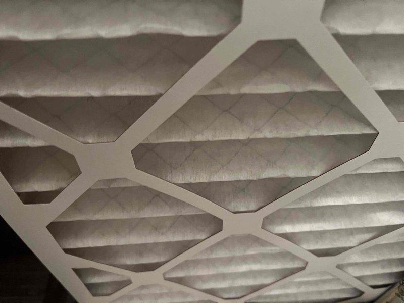 Completed comprehensive BFMA tune-up service on a one-year-old residential air conditioning system. Performed full system inspection of outdoor condensing unit, verified proper operation of condenser fan and compressor, checked refrigerant levels, and inspected electrical connections. Evaluated and documented condition of air filter showing moderate dust accumulation, confirmed adequate airflow through pleated media, and ensured proper system performance for optimal cooling efficiency.