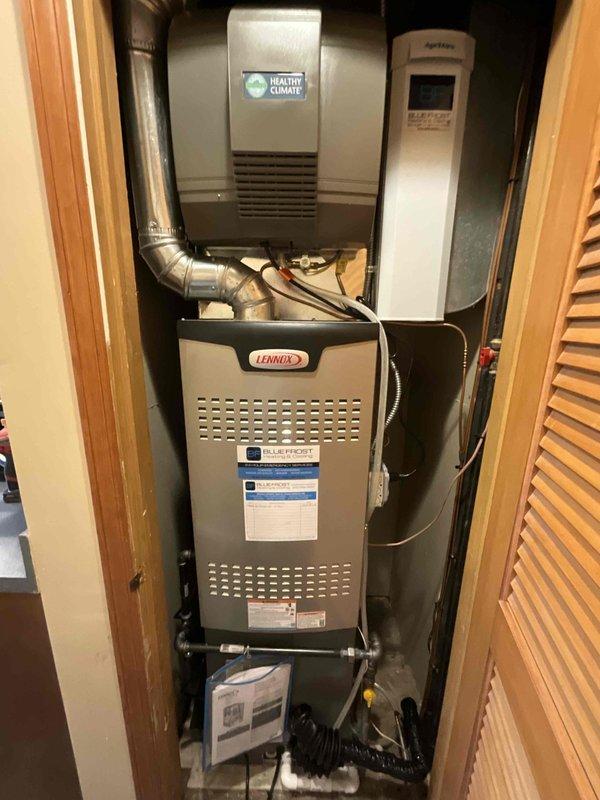 Completed full HVAC split system installation on first floor consisting of Lennox EL15KC1-030 air conditioner, SL280DF090V36B downflow furnace rated at 80% AFUE, Healthy Climate humidifier model 1410, and Ecobee smart thermostat. Relocated existing condenser unit 12 feet from original position, installing new electrical whip and refrigerant lineset to accommodate the repositioning. Installed all equipment in interior utility closet with vertical stacking configuration including furnace, humidifier, and air purification system, connected with flexible aluminum ductwork. Positioned outdoor condensing unit on concrete pad with proper clearances, completed all electrical connections, refrigerant line installation, condensate drainage, and thermostat wiring. System tested and operational upon completion.