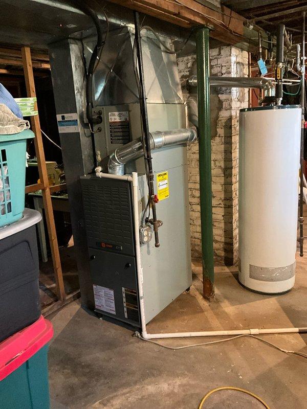 Completed comprehensive BFMA tune-up service on 17-year-old residential HVAC system located in basement mechanical room. Performed full system inspection including blower assembly evaluation, noting dust accumulation on squirrel cage fan blades and housing which was cleaned during service. Conducted standard AC tune-up procedures including filter inspection, electrical connection verification, refrigerant level check, condensate drain assessment, and thermostat calibration to ensure optimal system performance for the cooling season.