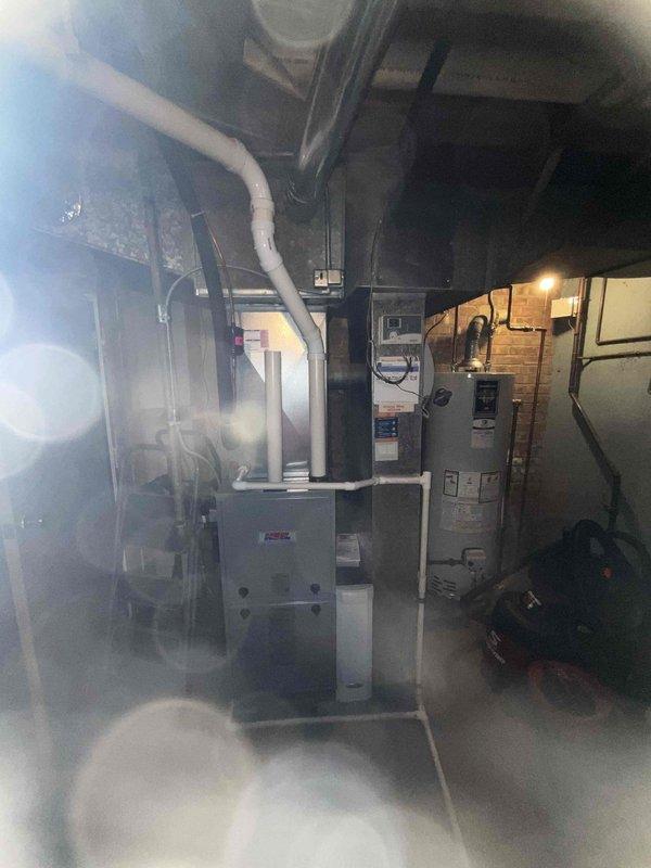 Completed comprehensive BFMA tune-up on 5-year-old residential furnace system located in basement mechanical room. Performed standard maintenance procedures including system diagnostics, electrical testing with digital multimeter to verify proper voltage and amperage readings, inspected all components for wear and operational efficiency, cleaned burner assembly, checked gas pressure, tested safety controls, and verified proper venting through PVC exhaust system. All systems tested within manufacturer specifications and unit operating efficiently.