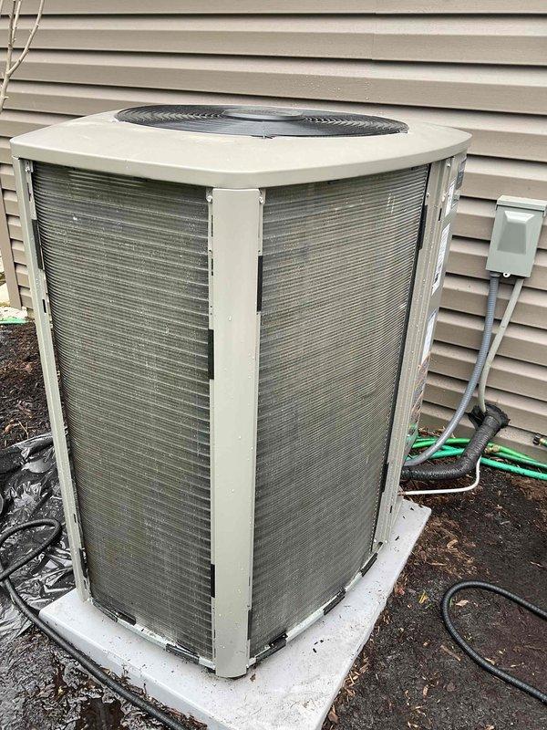 Completed comprehensive BFMA tune-up on 7-month-old residential air conditioning system. Performed standard preventive maintenance including inspection of outdoor condenser unit, verification of refrigerant line connections, assessment of heat exchanger fins and coil condition, and evaluation of overall system operation. Unit found in good working condition with minor dirt accumulation on exterior surfaces; confirmed proper installation on concrete pad with adequate clearance for airflow and servicing access.
