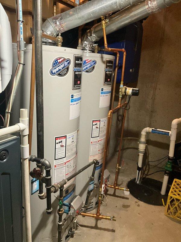 Completed comprehensive plumbing maintenance visit and inspection of residential water heating system. Documented dual InSinkErator instant hot water units and Bradford White water heater installation, including copper piping connections, pressure relief valves, shut-off valves, and associated plumbing infrastructure. All equipment photographed for maintenance records, with no immediate repairs required at time of visit.