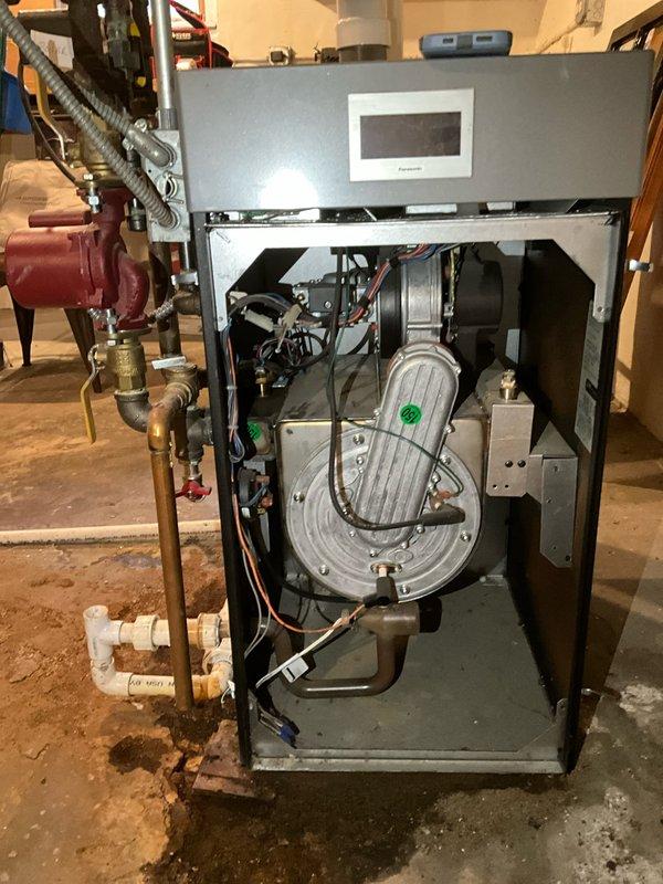 Responded to after hours call for heating system issue. Upon arrival, inspected ASCO-specified boiler unit model ALP150B (serial number 8410678, manufactured 09/2012) with 120V/60Hz electrical specifications. Removed front access panel to assess internal components and heat exchanger condition. Documented equipment specifications from manufacturer label including BTU ratings, gas pressure parameters, and steam capacity information. Verified all electrical connections, including red and black wiring to control panel and digital display unit. Inspected circulation pump operation and associated copper piping with brass fittings for proper function. Checked all plumbing connections and valve assemblies for leaks or operational concerns. Photographed equipment nameplate data and internal components for service records. System evaluated and operational status confirmed before departing site.
