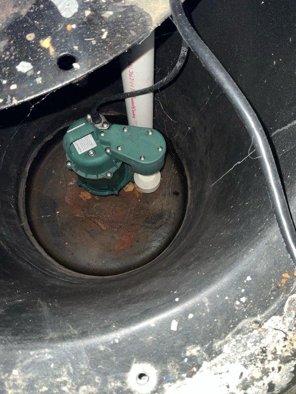 Completed comprehensive plumbing inspection as part of preventive maintenance tune-up service. Inspected sump pump system in basement, verifying proper operation of green submersible pump unit with float switch assembly and confirming adequate drainage in basin. Examined bathroom shower plumbing fixtures including chrome faucet assembly and verified proper water flow and temperature control with no leaks detected at valve connections or spout.
