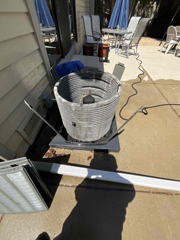 Completed comprehensive BFMA tune-up service on a 2-year-old residential air conditioning system during morning hours per customer preference. Performed thorough inspection of outdoor condenser unit, including examination of cylindrical coil assembly, fan motor housing, and electrical connections. Documented equipment condition with detailed photography showing proper operation of all components and verified unit cleanliness and mounting integrity.