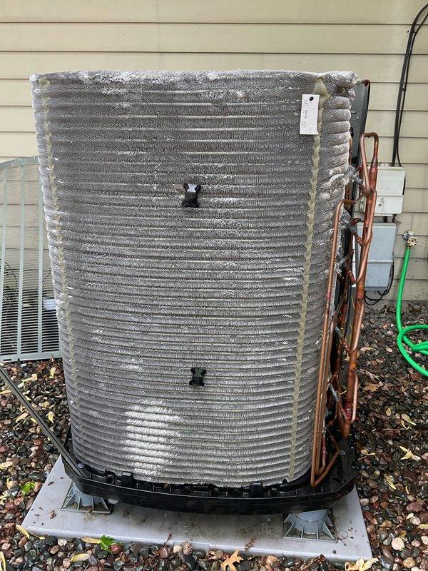 Completed comprehensive BFMA tune-up on 1-year-old air conditioning system, including inspection of indoor air handler with multi-panel filter array and outdoor condenser unit. Identified significant frost accumulation on condenser coils indicating potential airflow restriction, low refrigerant charge, or system operational issue requiring further diagnostic evaluation. Performed standard maintenance protocol including filter inspection, visual assessment of refrigerant lines and electrical connections, and documentation of system conditions for ongoing service tracking.