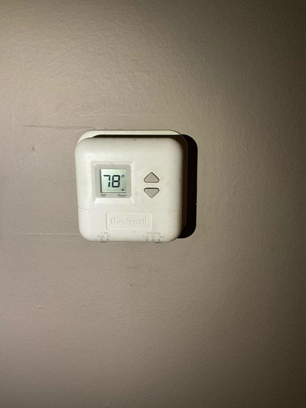 Completed comprehensive BFMA tune-up service on a 5-year-old air conditioning system. Performed full system inspection including thermostat operation verification at 78°F setpoint. Accessed outdoor condensing unit and inspected condenser coil, noting moderate accumulation of dirt and debris between fins with visible discoloration along center section. Checked electrical connections and control wiring for proper termination and secure fastening. Conducted standard maintenance procedures including performance testing and operational assessment of all system components to ensure proper cooling function.