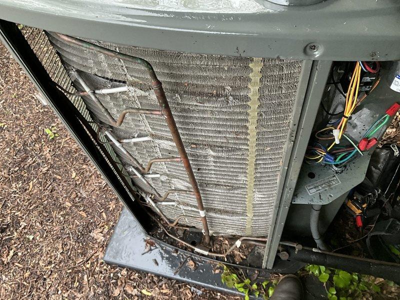 Completed comprehensive BFMA tune-up service on a 5-year-old air conditioning system. Performed full system inspection including thermostat operation verification at 78°F setpoint. Accessed outdoor condensing unit and inspected condenser coil, noting moderate accumulation of dirt and debris between fins with visible discoloration along center section. Checked electrical connections and control wiring for proper termination and secure fastening. Conducted standard maintenance procedures including performance testing and operational assessment of all system components to ensure proper cooling function.