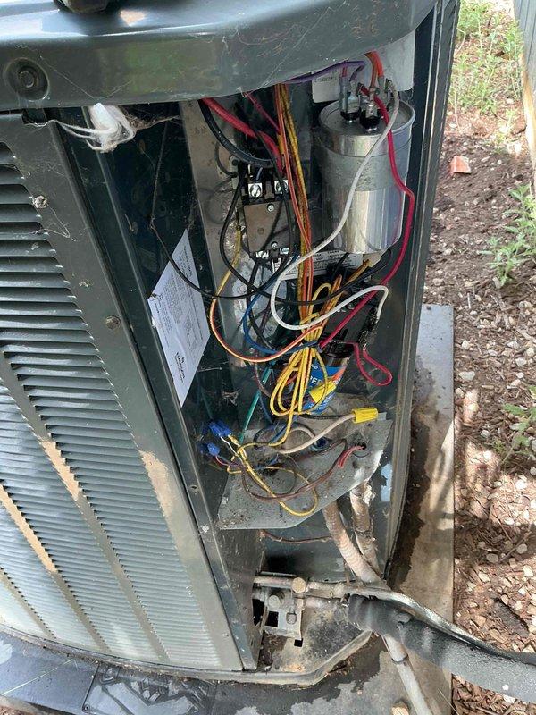Completed comprehensive BFMA tune-up on 10+ year old outdoor AC unit as first appointment of the day. Performed full system inspection with access panel removed, evaluated electrical components including capacitor, contactors, and wiring harness connections, and conducted diagnostic testing using digital clamp meter to verify proper electrical readings and system performance. All components found operational with connections properly secured despite unit showing normal age-related exterior weathering.