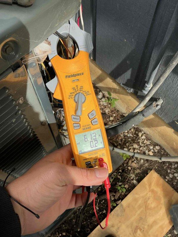 Completed comprehensive BFMA tune-up on 10+ year old outdoor AC unit as first appointment of the day. Performed full system inspection with access panel removed, evaluated electrical components including capacitor, contactors, and wiring harness connections, and conducted diagnostic testing using digital clamp meter to verify proper electrical readings and system performance. All components found operational with connections properly secured despite unit showing normal age-related exterior weathering.