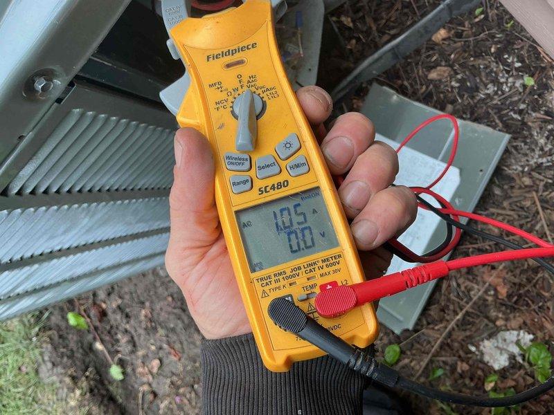 Completed comprehensive BFMA tune-up service on 8-year-old air conditioning system during scheduled afternoon appointment. Performed full system diagnostics including electrical measurements with clamp meter showing 185-amp reading, inspected outdoor condenser unit and indoor evaporator coil assembly. Noted aged foam insulation on refrigerant lines showing deterioration and copper piping displaying oxidation with blue-green patina, along with dust accumulation on evaporator coil fins; system operational and all measurements within acceptable parameters for continued service.