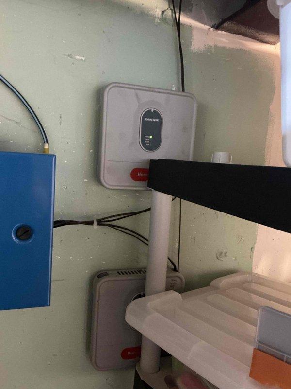 Conducted sales estimate for high-efficiency air conditioning system upgrade. Customer's existing AC unit is currently operational but requesting evaluation for high-efficiency replacement options. Documented existing HVAC control system including Resideo thermostat/control unit with smart home integration capabilities and associated mechanical components in utility area for proper equipment sizing and compatibility assessment.
