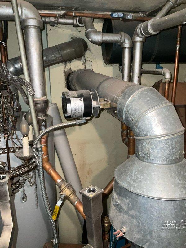 Responded to service call for non-operational boiler system in residential mechanical room. Conducted comprehensive assessment of existing heating equipment, including navy-colored boiler unit, associated ductwork, copper and PVC piping connections, and interconnected HVAC components. Documented current system configuration with detailed photographs showing boiler installation, flexible silver insulated ductwork, gas lines, water supply connections, and mechanical equipment layout for estimate preparation purposes.